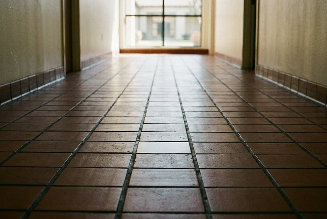 Terracotta tile hallway floor near an entry door